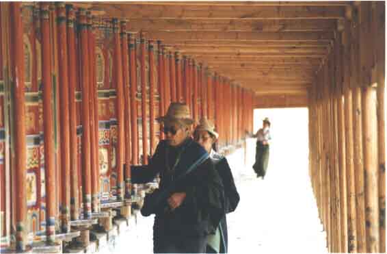 Tibtan Buddhists spin prayer wheels in Xiahe, Gansu